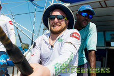 Auf dem Bild sieht man Angler auf einem Boot vor den Malediven, die mit Spannung eine Angelrute halten. Perfektes Abenteuer für Sportangler, die Meeresangeln und atemberaubende Fischfänge in tropischen Gewässern erleben möchten.