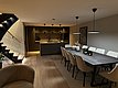 Moderne offene Küche in Südwest-Norwegen: Stilvolles Design mit großzügigem Esstisch, eleganten Hängeleuchten und Treppe im Hintergrund, ideal für gemütliche Angelurlaubsabende.