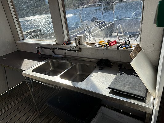 Angelreiseziel Hitra, Norwegen: Moderne Ausstattungen, darunter Spülbecken und Reinigungszubehör, ideal zum Aufbereiten des Tagesfangs. Perfekt für einen komfortablen Angelurlaub mit Zugang zu hochwertigen Booten in beeindruckender Naturkulisse.