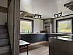 Moderne, minimalistische Küche in Ferienhaus, Nordland, Norwegen. Blick auf Waldlandschaft durch zwei große Fenster. Holzverkleidung sorgt für gemütliches Ambiente. Ideal für einen entspannten Angelurlaub in malerischer Umgebung.