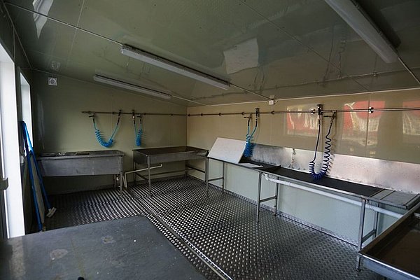 Moderner, gut ausgestatteter Filetierraum in Nordland, Norwegen, mit hygienischen Arbeitsplätzen und spritzwassergeschützten Wänden. Perfekt für Angler zur Verarbeitung frischer Fänge. Ideal für Angelurlaube und Meeresangeln-Enthusiasten.