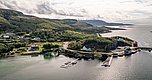 Luftbild von Hitra, Norwegen: malerische Küstenlinie mit grünen Hügeln, kleinen Dörfern und Hafen. Perfekter Ort für Angelabenteuer und Naturerlebnisse. Ideal für Angelurlaub und Meeresangeln.